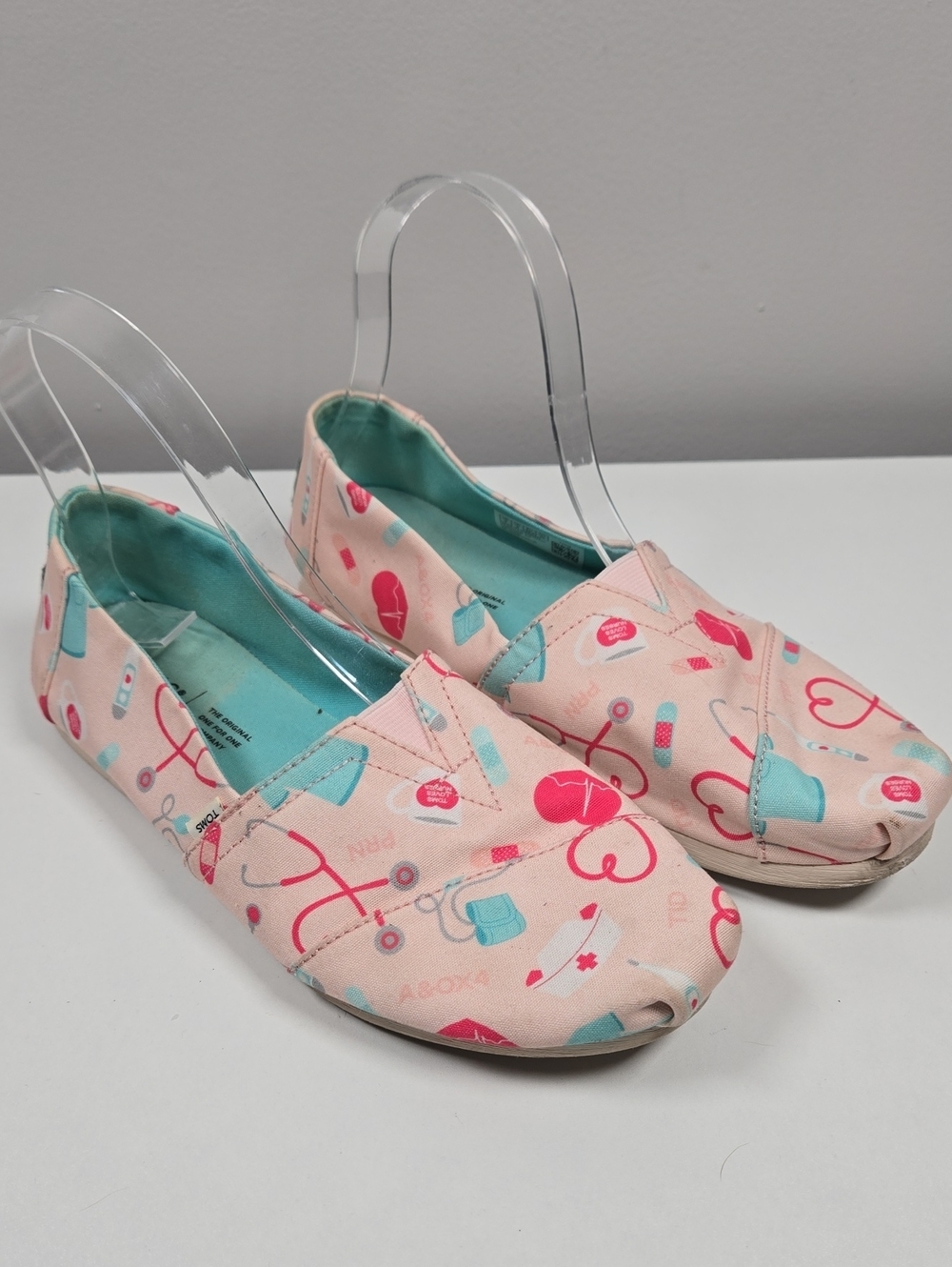 TOMS Pink Canvas Slip-Ons with Teal Lining and Medical Print